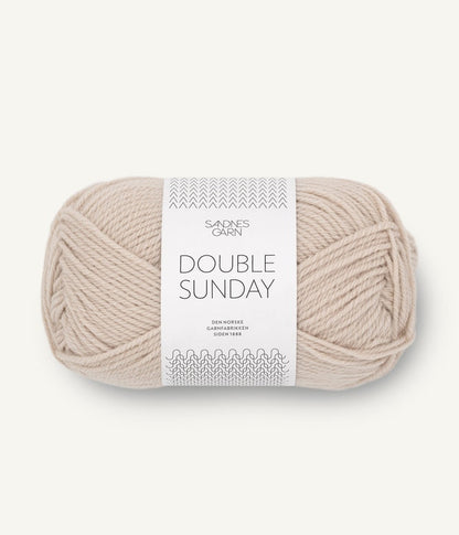 A ball of beige coloured merino wool yarn labeled 'Double Sunday' by Sandnesgarn.