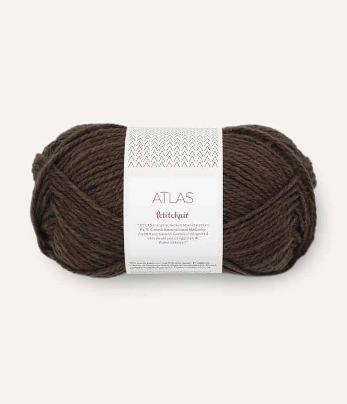Brown skein of yarn with a label on a white background
