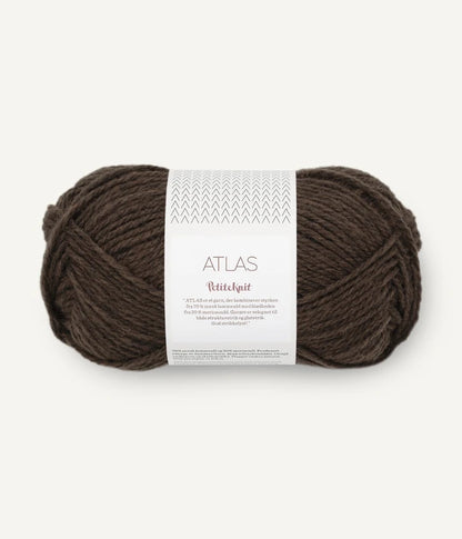 Brown skein of yarn with a label on a white background