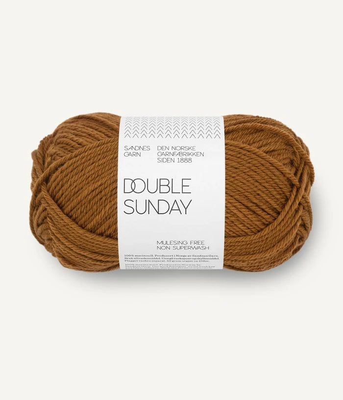 A ball of brown-gold coloured merino wool yarn labeled 'Double Sunday' by Sandnesgarn.