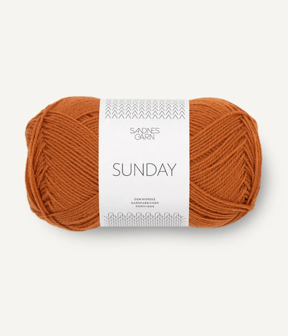 A ball of Sandnesgarn Sunday merino wool yarn in an orange color, with packaging that includes the brand and product name.