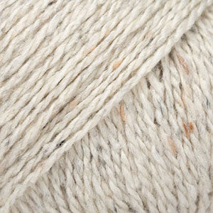 Close-up of white and rose wool/alpaca/viscose yarn from Drops
