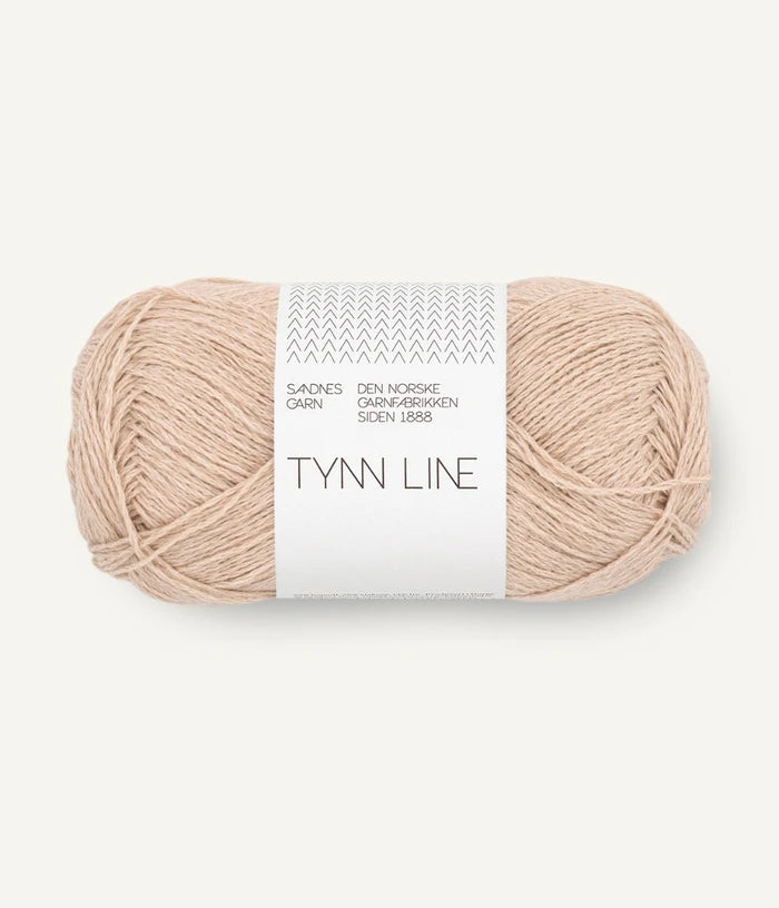 A ball of beige cotton/linen/viscose yarn labeled 'TYNN LINE' by Sandnes Garn