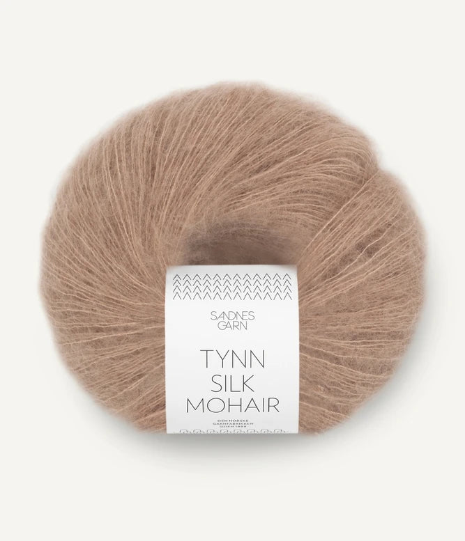 A ball of Tynn Silk Mohair yarn in an acorn color with a 'Tynn Silk Mohair' label from Sandnes Garn