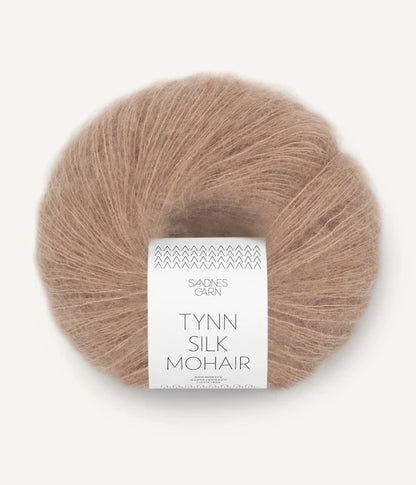 A ball of Tynn Silk Mohair yarn in an acorn color with a 'Tynn Silk Mohair' label from Sandnes Garn