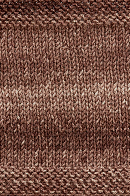 A knitted swatch of brown tonal superwash merino wool yarn from Urth