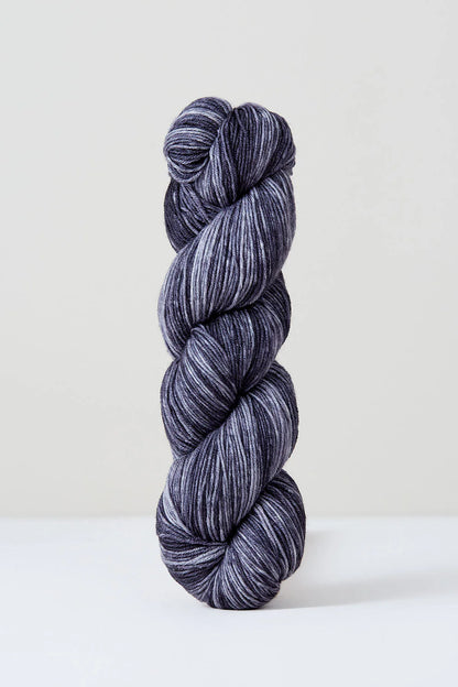 A skein of grey tonal superwash merino wool yarn from Urth