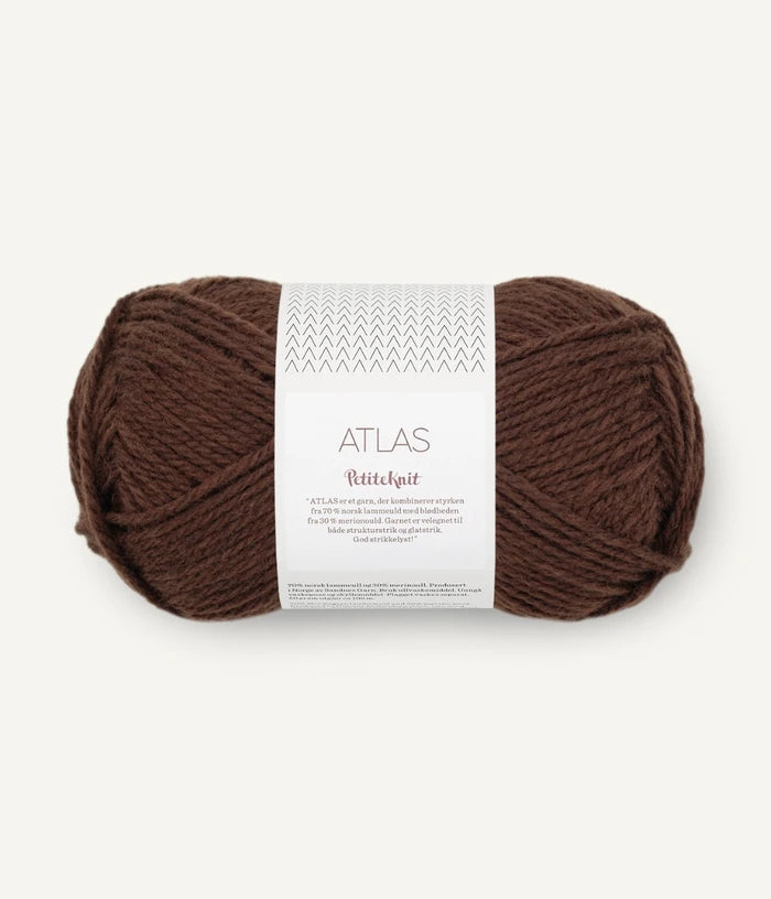 Brown yarn ball with a label on a white background