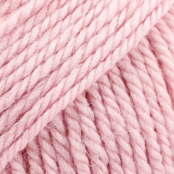 Close-up of powder pink wool and alpaca yarn from Drops