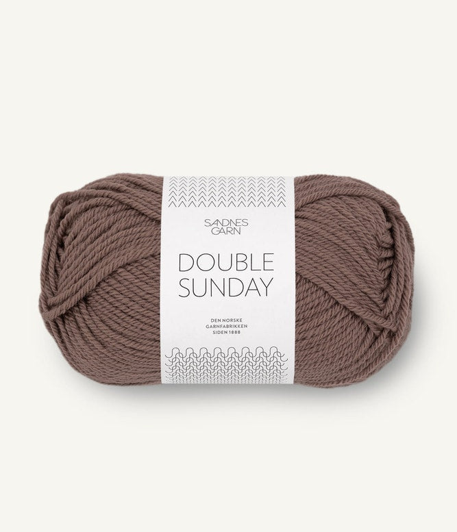 A ball of light brown coloured merino wool yarn labeled 'Double Sunday' by Sandnesgarn.