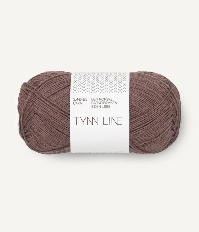 A ball of acorn brown cotton/linen/viscose yarn labeled 'TYNN LINE' by Sandnes Garn
