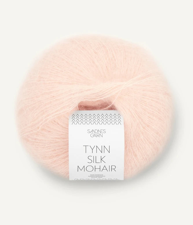 A ball of Tynn Silk Mohair yarn in a ballet pink color with a 'Tynn Silk Mohair' label from Sandnes Garn