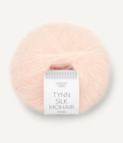 A ball of Tynn Silk Mohair yarn in a ballet pink color with a 'Tynn Silk Mohair' label from Sandnes Garn