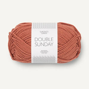 A ball of light copper brown coloured merino wool yarn labeled 'Double Sunday' by Sandnesgarn.