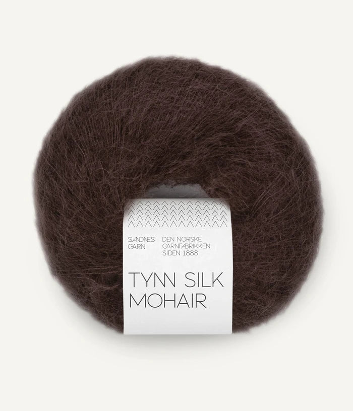 A ball of Tynn Silk Mohair yarn in a brown-red color with a 'Tynn Silk Mohair' label from Sandnes Garn
