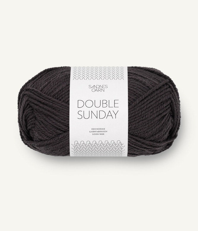 A ball of light black coloured merino wool yarn labeled 'Double Sunday' by Sandnesgarn.