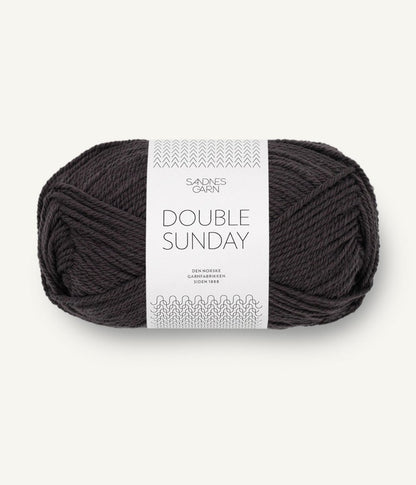 A ball of light black coloured merino wool yarn labeled 'Double Sunday' by Sandnesgarn.