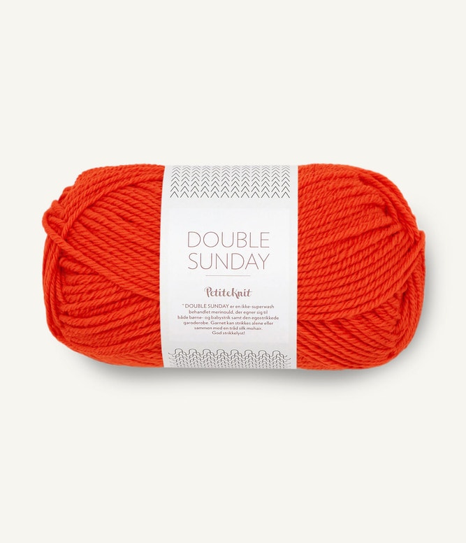 A ball of bright orange coloured merino wool yarn labeled 'Double Sunday' by Sandnesgarn.