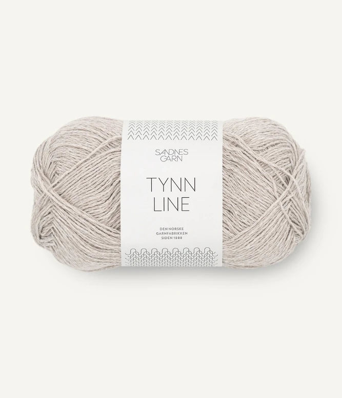 A ball of white-grey cotton/linen/viscose yarn labeled 'TYNN LINE' by Sandnes Garn