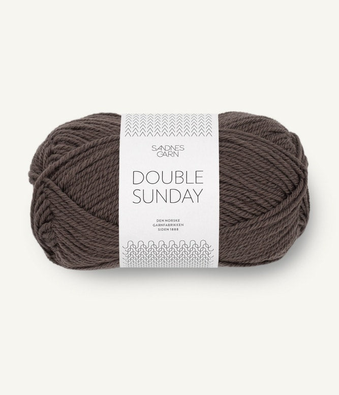 A ball of brown-black coloured merino wool yarn labeled 'Double Sunday' by Sandnesgarn.