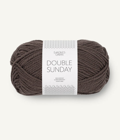 A ball of brown-black coloured merino wool yarn labeled 'Double Sunday' by Sandnesgarn.
