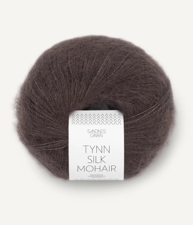 A ball of Tynn Silk Mohair yarn in a medium brown color with a 'Tynn Silk Mohair' label from Sandnes Garn