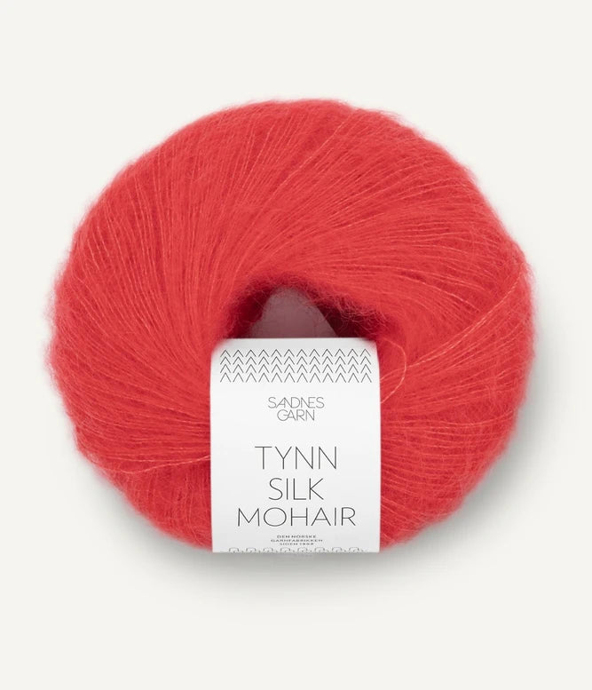 A ball of Tynn Silk Mohair yarn in a poppy color with a 'Tynn Silk Mohair' label from Sandnes Garn