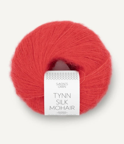 A ball of Tynn Silk Mohair yarn in a poppy color with a 'Tynn Silk Mohair' label from Sandnes Garn