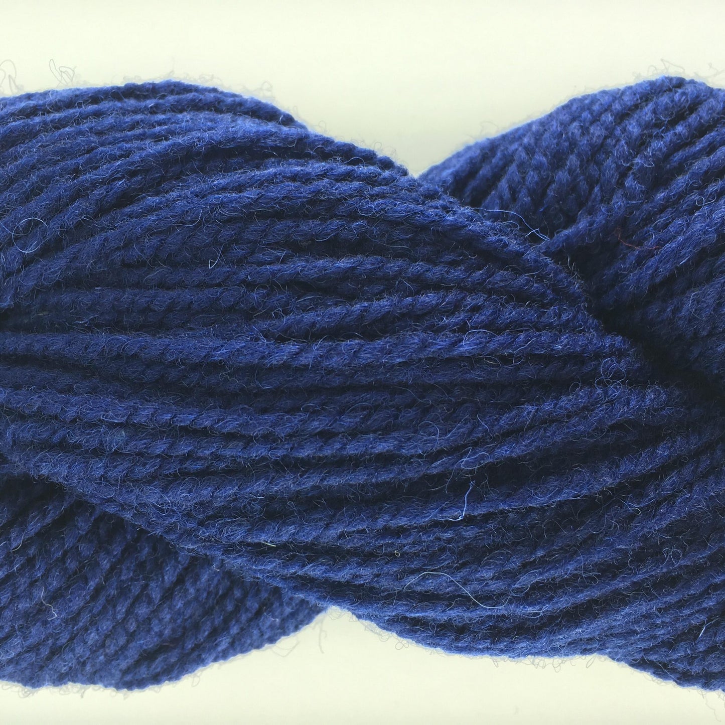 Close-up of a skein of navy coloured wool yarn