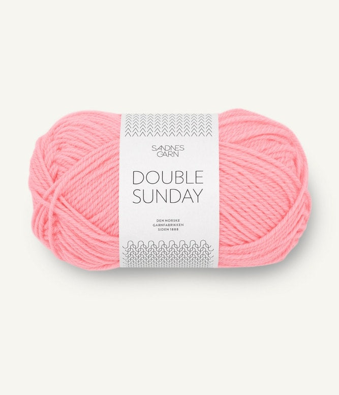 A ball of bright pink coloured merino wool yarn labeled 'Double Sunday' by Sandnesgarn.