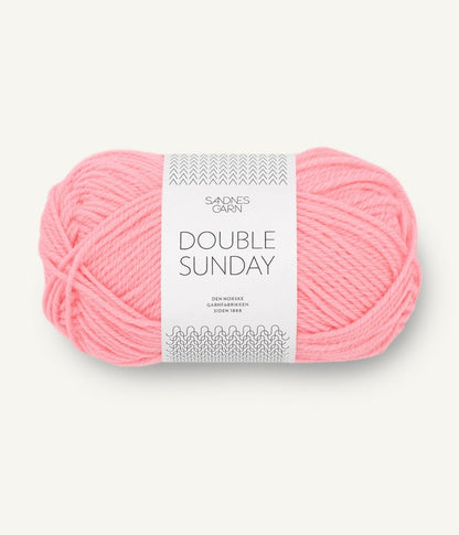 A ball of bright pink coloured merino wool yarn labeled 'Double Sunday' by Sandnesgarn.