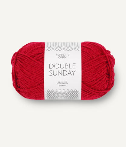 A ball of red coloured merino wool yarn labeled 'Double Sunday' by Sandnesgarn.