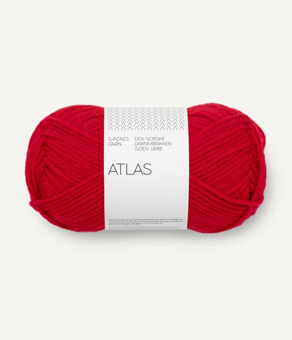 Red skein of yarn with a white label on a white background