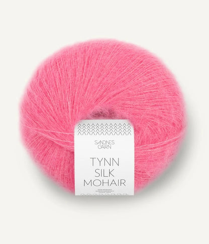 A ball of Tynn Silk Mohair yarn in a bubblegum pink color with a 'Tynn Silk Mohair' label from Sandnes Garn