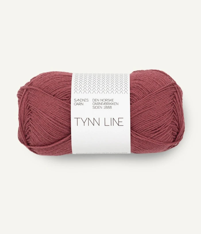 A ball of dusty rose cotton/linen/viscose yarn labeled 'TYNN LINE' by Sandnes Garn