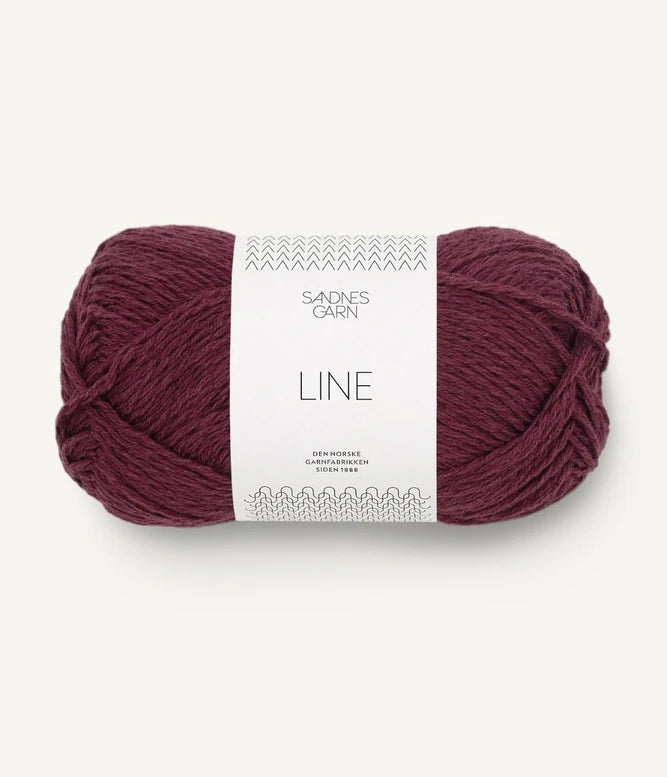 A ball of burgundy coloured cotton/linen/viscose yarn labeled 'Line' by Sandnesgarn