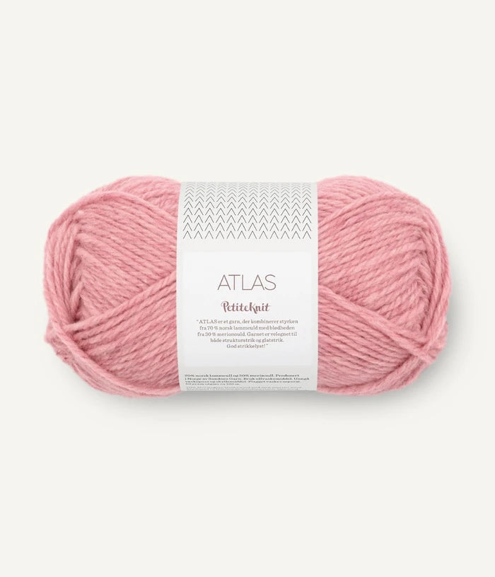 Pink skein of yarn with a label on a white background