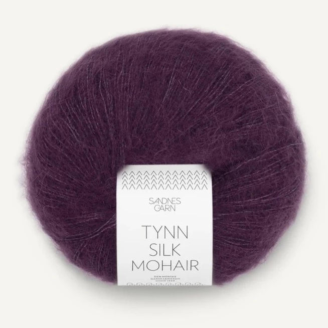 A ball of Tynn Silk Mohair yarn in a blackberry color with a 'Tynn Silk Mohair' label from Sandnes Garn