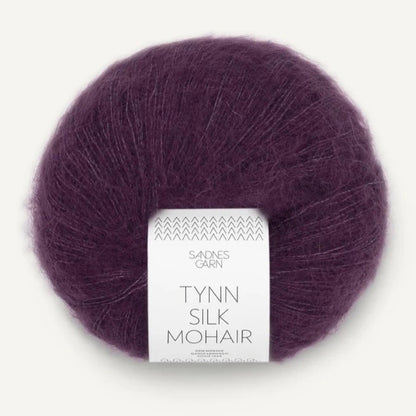 A ball of Tynn Silk Mohair yarn in a blackberry color with a 'Tynn Silk Mohair' label from Sandnes Garn