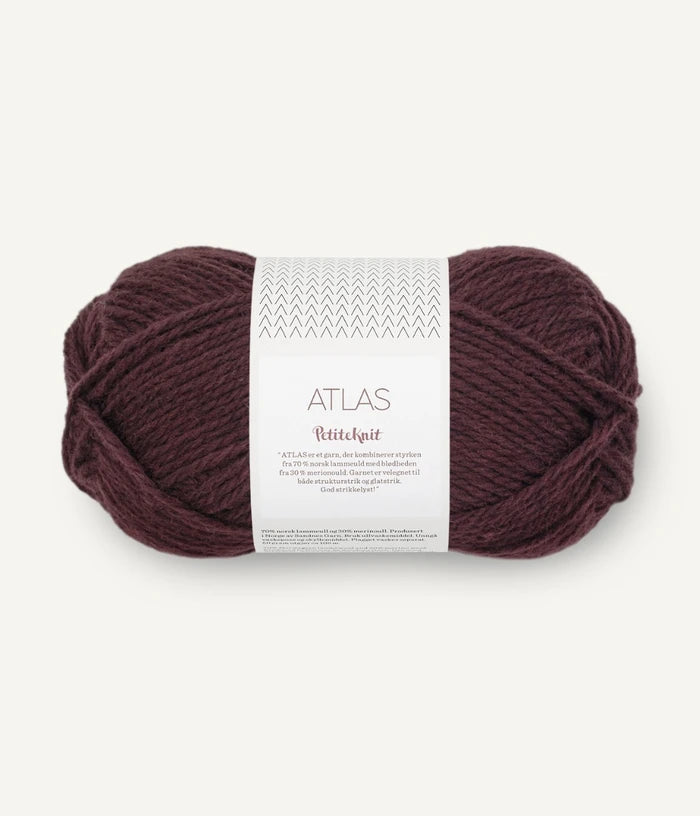 Ball of Deep Wine coloured yarn with a label on a white background