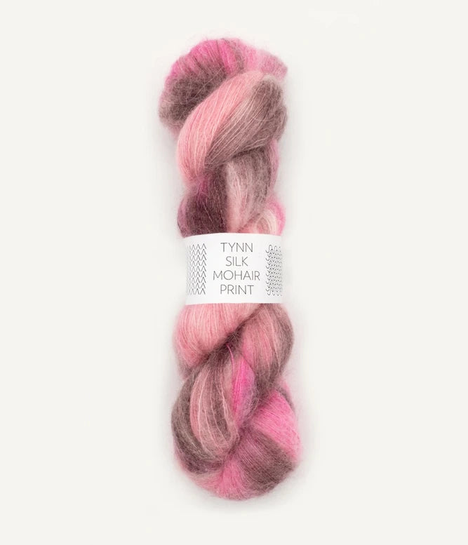 A skein of Tynn Silk Mohair print yarn in a blend of brown and pink colors