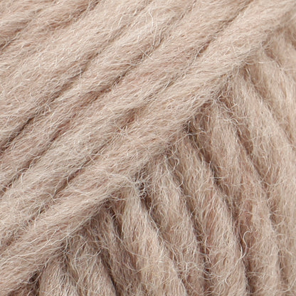 Close-up of a ball of light beige-colored wool yarn from Drops