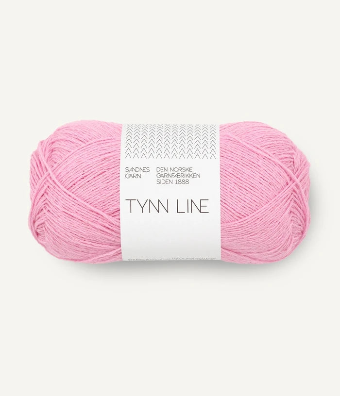 A ball of bright pink cotton/linen/viscose yarn labeled 'TYNN LINE' by Sandnes Garn