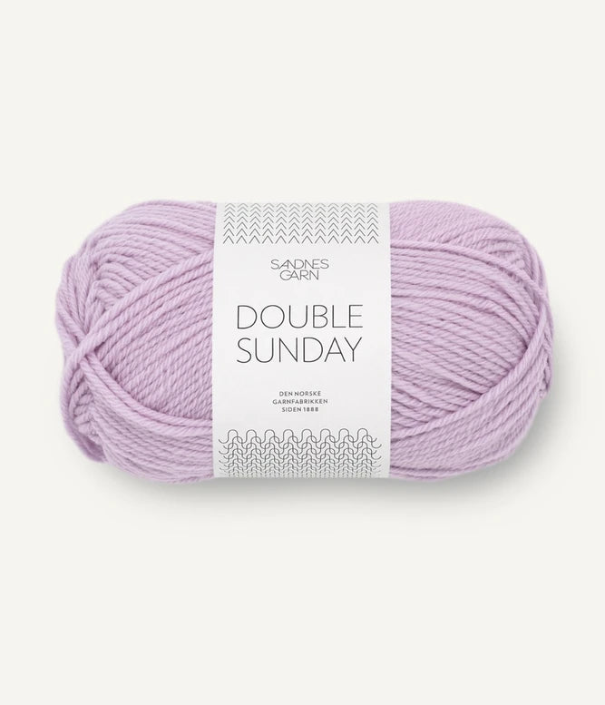 A ball of lilac coloured merino wool yarn labeled 'Double Sunday' by Sandnesgarn.