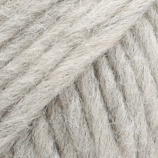 Close-up of a ball of light grey-colored wool yarn from Drops