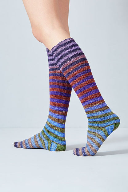 Merino and nylon knit blue, purple, green, and rust stripe socks from Urth