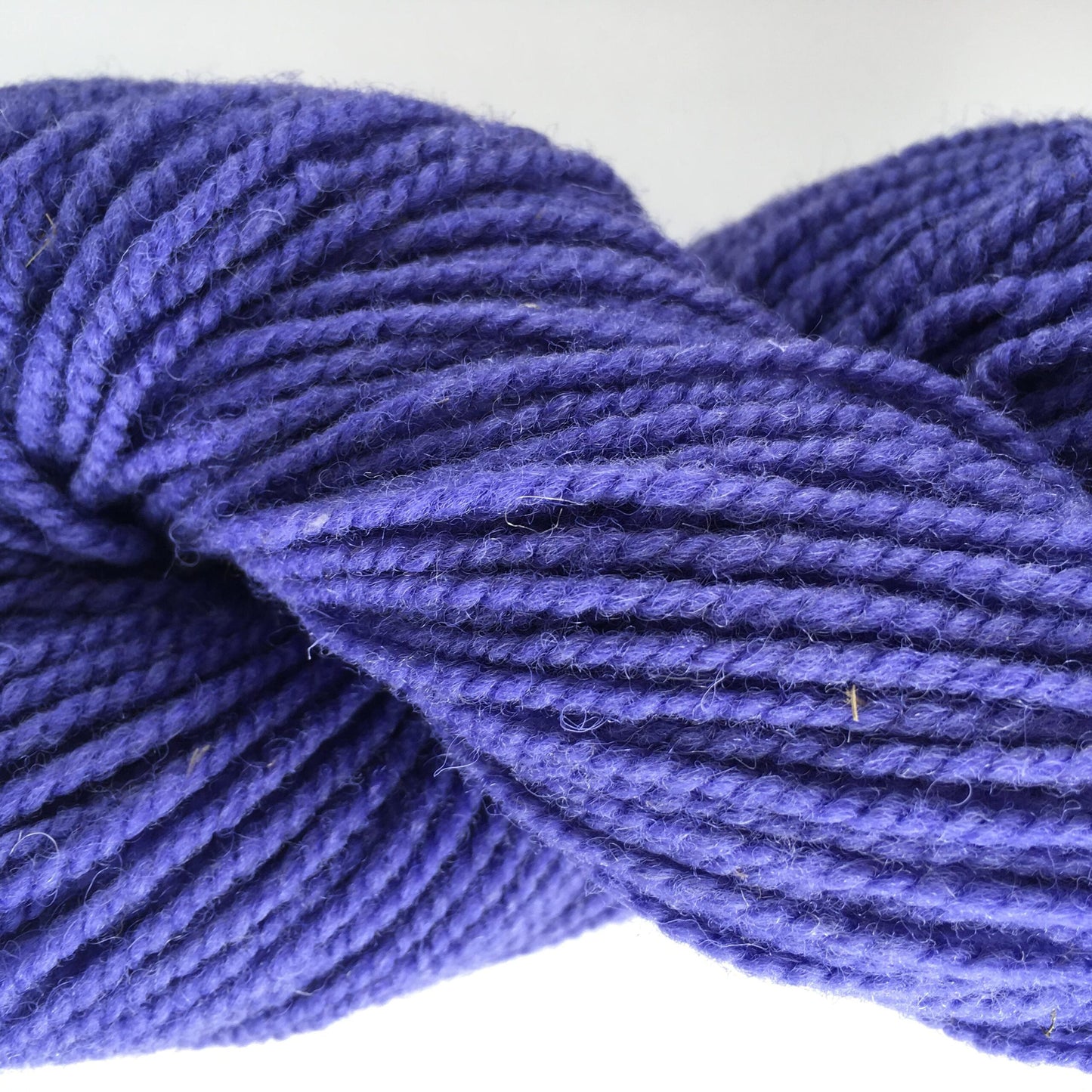 Close-up of a skein of purple coloured wool yarn