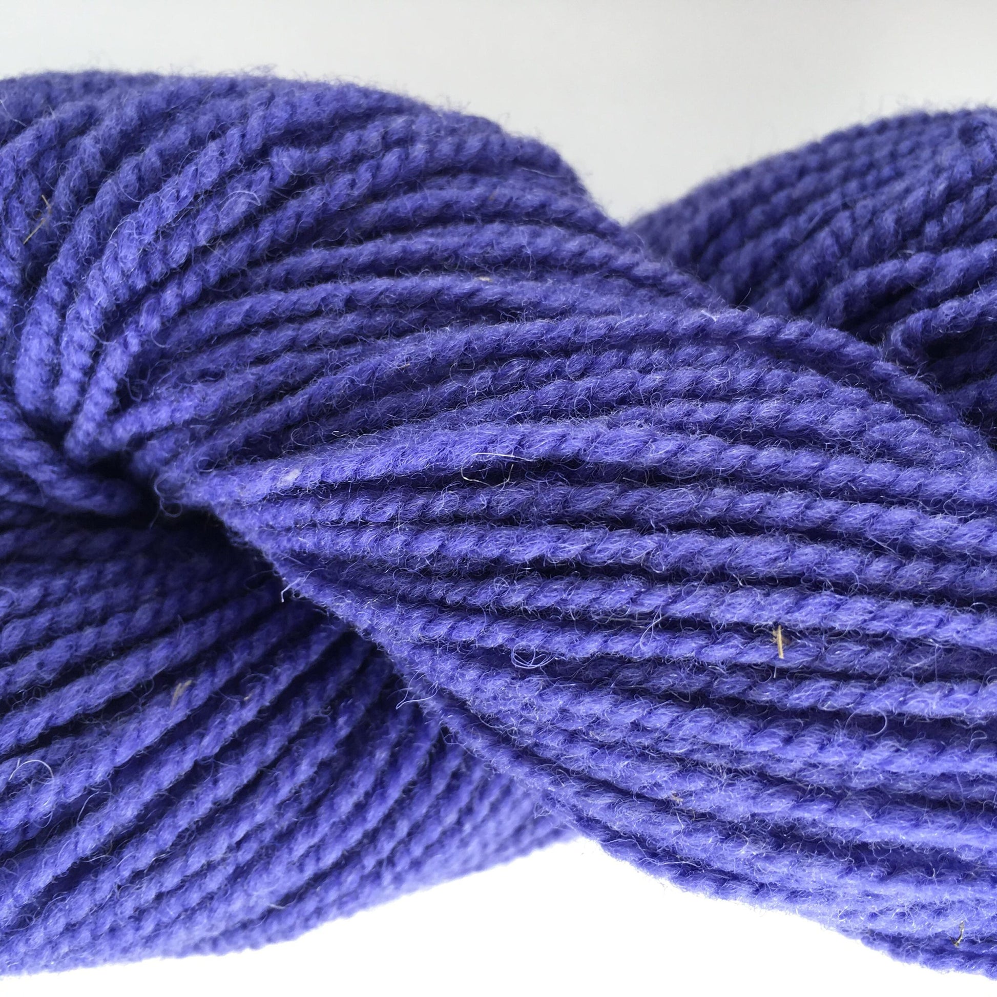 Close-up of a skein of purple coloured wool yarn