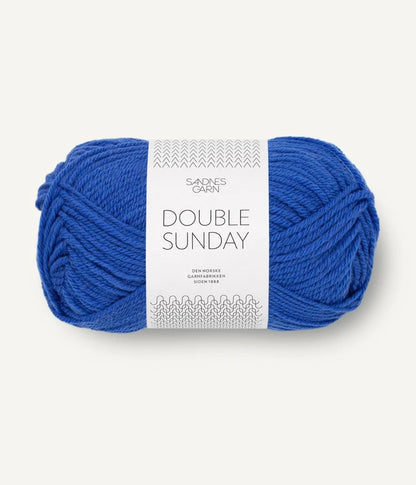 A ball of cobalt blue coloured merino wool yarn labeled 'Double Sunday' by Sandnesgarn.