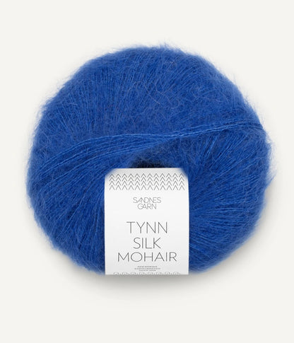 A ball of Tynn Silk Mohair yarn in a cobalt blue color with a 'Tynn Silk Mohair' label from Sandnes Garn